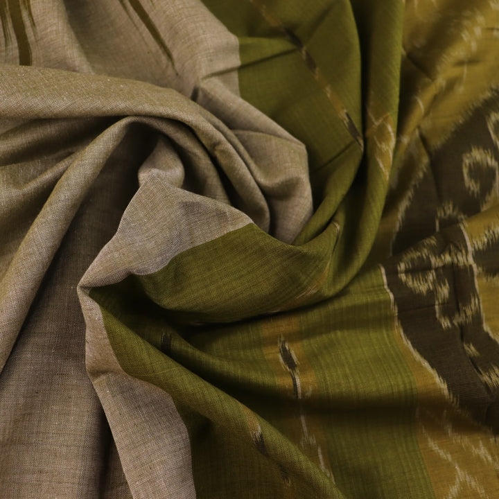 Plain green Sambalpuri cotton saree, showcasing elegant drape.