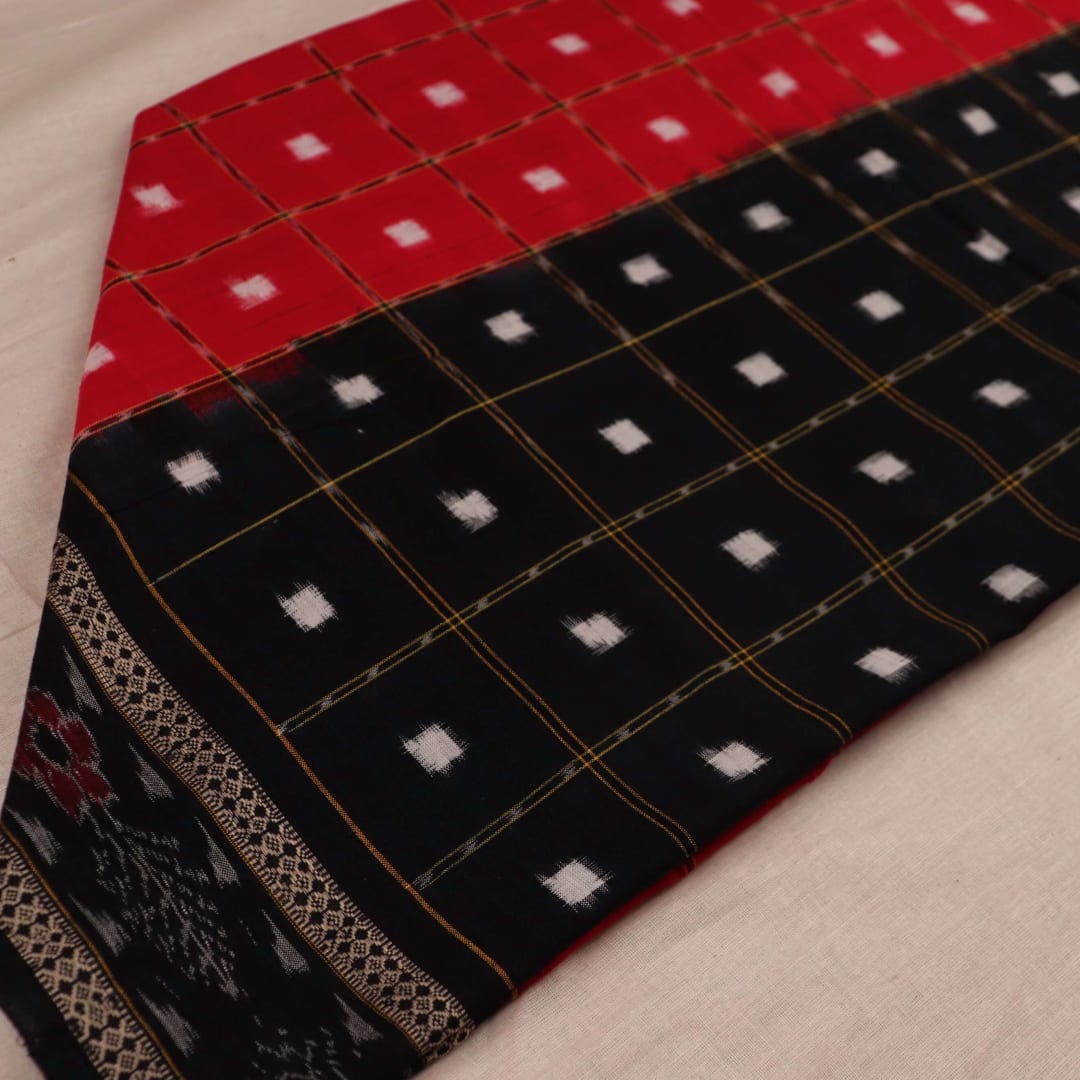 Red and black Sambalpuri cotton dupatta with intricate motifs, styled elegantly