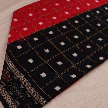 Red and black Sambalpuri cotton dupatta with intricate motifs, styled elegantly