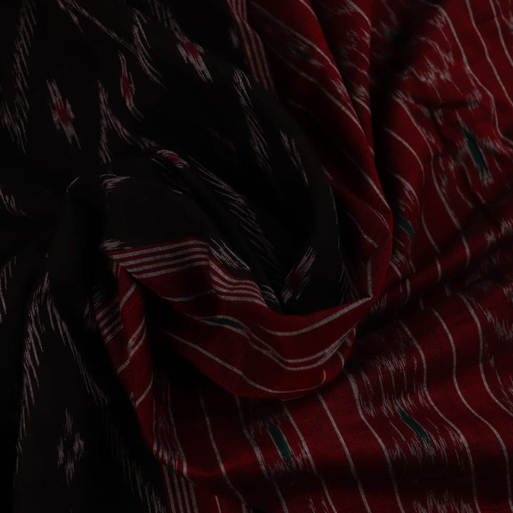 Model wearing a black and red Sambalpuri cotton saree, showing drape and overall style.