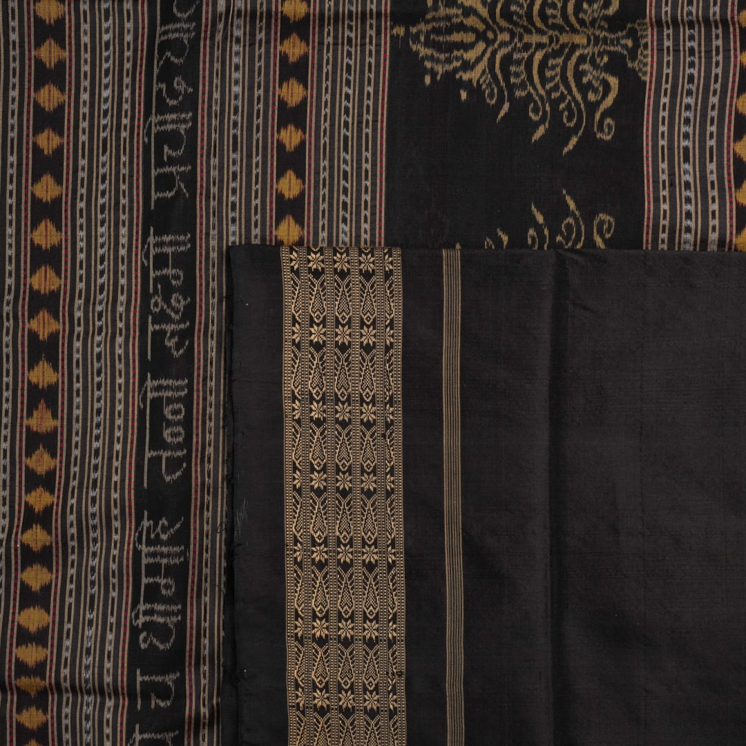 Micro close-up of the maroon Sambalpuri silk fabric, revealing its luxurious texture and handloom weave.