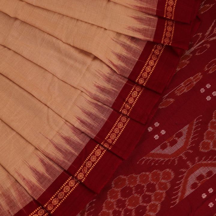 Cream-colored Sambalpuri cotton saree with maroon butta motifs, styled on a model