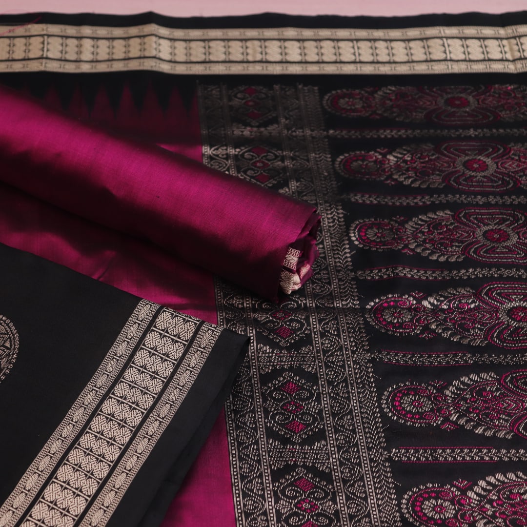 Close-up of Bomkai silk dress material blouse piece, black with magenta butta pattern.