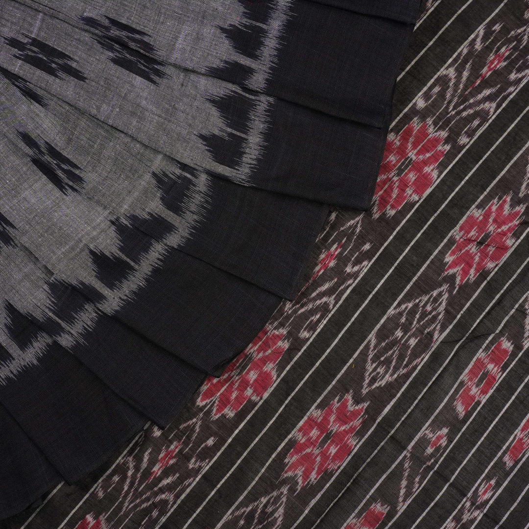 Model styled in a grey and black Sambalpuri cotton saree showing the elegant drape and traditional motifs.