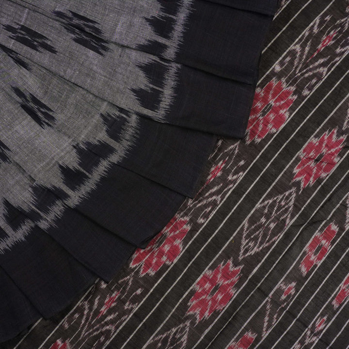 Model styled in a grey and black Sambalpuri cotton saree showing the elegant drape and traditional motifs.