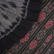 Model styled in a grey and black Sambalpuri cotton saree showing the elegant drape and traditional motifs.