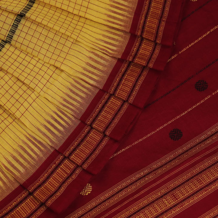 Full view of yellow and maroon cotton Sambalpuri saree featuring a butta pattern.