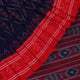 Gracefully draped blue Sambalpuri cotton saree with red motifs, highlighting its design and flow.