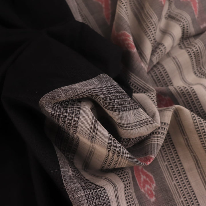 Full view of a plain black and white Sambalpuri cotton handloom saree.