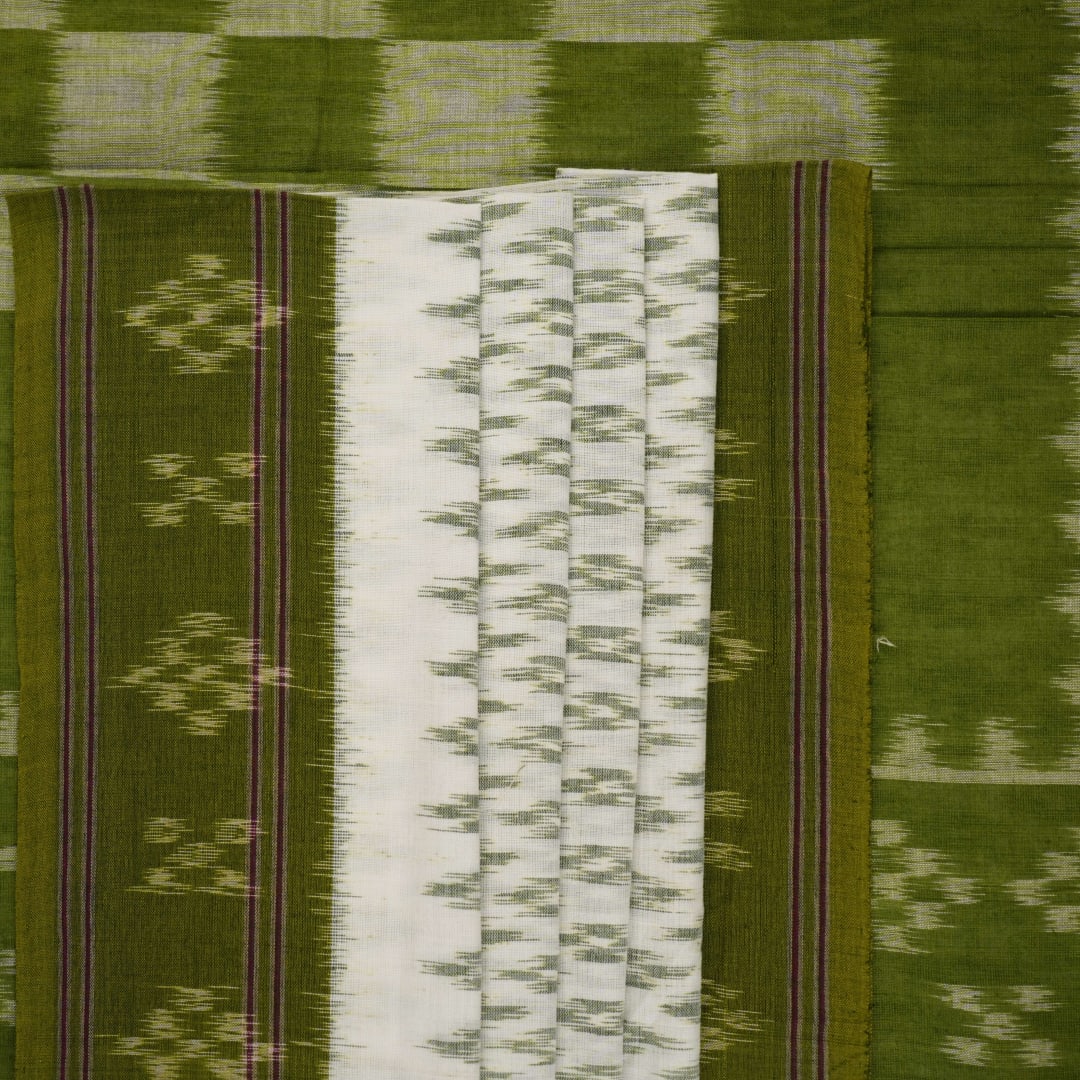 Model wearing a white and green Sambalpuri cotton saree, demonstrating the elegant drape and handloom motifs.