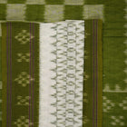 Model wearing a white and green Sambalpuri cotton saree, demonstrating the elegant drape and handloom motifs.