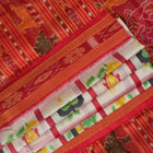 Model styled in a white and red Khandua silk saree showcasing its elegant fall and traditional Odia motifs.