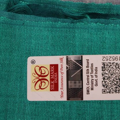 Close-up of textured grey and green Tussar silk fabric used in a plain pattern saree