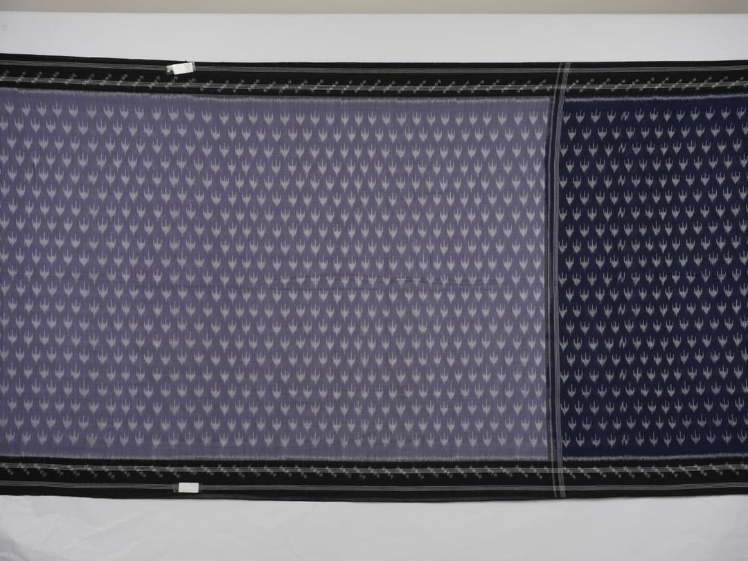 Model wearing a grey and black Sambalpuri cotton saree with traditional ikat motifs in a classic ethnic drape.