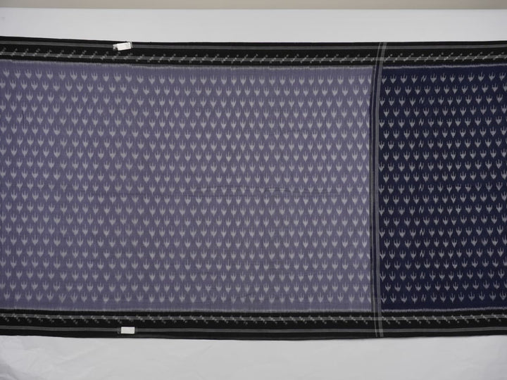 Model wearing a grey and black Sambalpuri cotton saree with traditional ikat motifs in a classic ethnic drape.