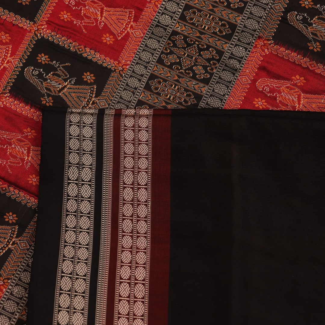 Close-up showcasing the smooth, golden-yellow silk texture of the Bomkai saree, adorned with intricate black butta patterns.