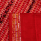 Close-up of the distinct handwoven texture of a red Sambalpuri silk saree with Butta pattern.