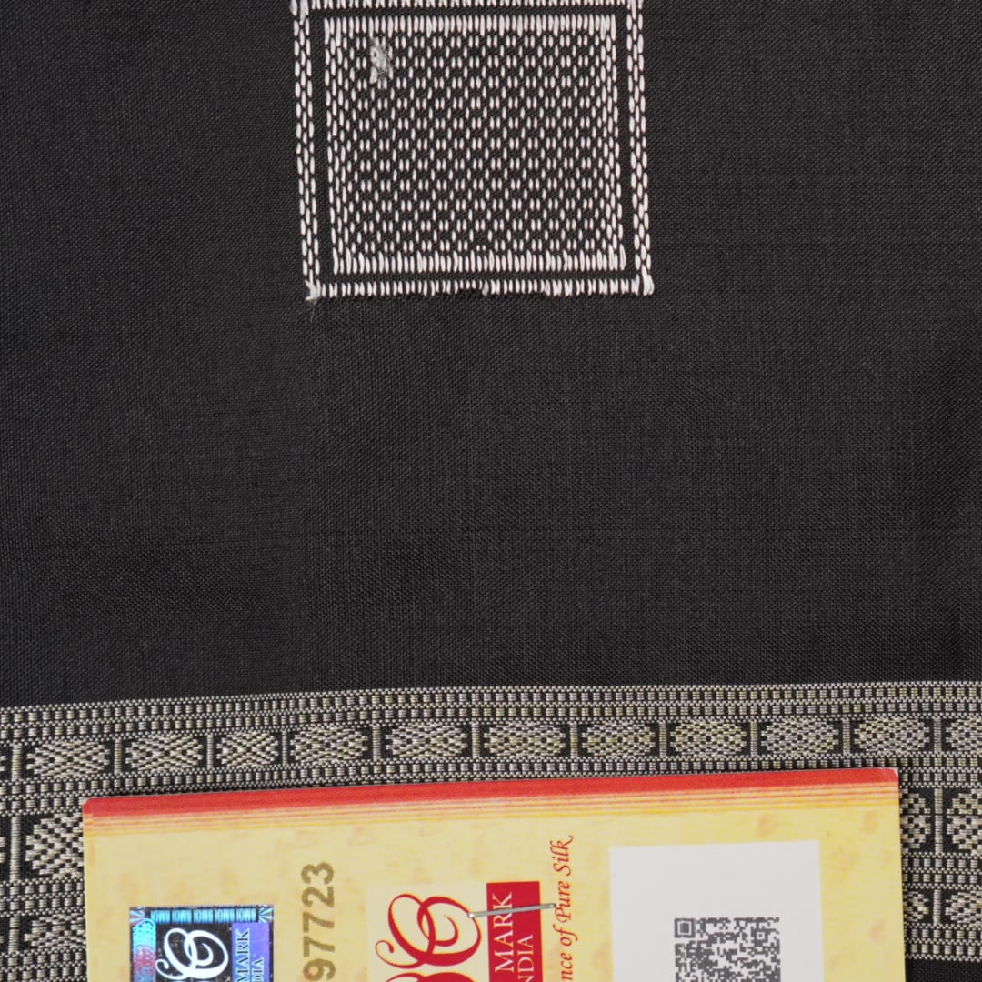 Extreme close-up of red Bomkai silk saree fabric showcasing rich texture and intricate weave.