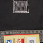 Extreme close-up of red Bomkai silk saree fabric showcasing rich texture and intricate weave.