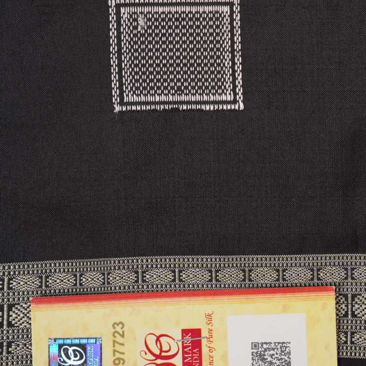 Extreme close-up of red Bomkai silk saree fabric showcasing rich texture and intricate weave.