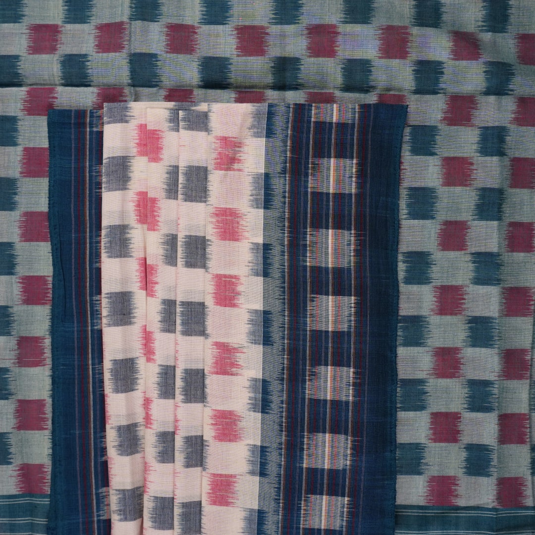 Styling view of a model draped in a white and blue Sambalpuri cotton saree with motif patterns