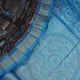 Close-up of Sambalpuri silk saree fabric, revealing rich blue multi-color weave texture and tissue motifs.