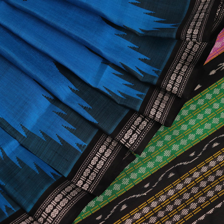 Close-up of intricate butta pattern on a silk blue and black Berhampuri saree