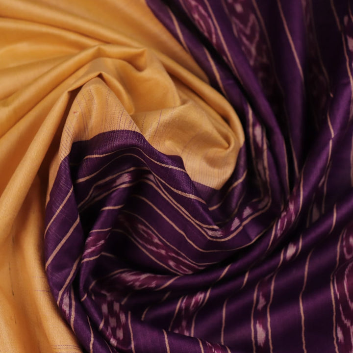 Close-up of cream tussar silk saree fabric with plain weave texture