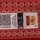 Close-up of a peach and red Sambalpuri silk saree fabric showing the intricate handloom texture and motifs.