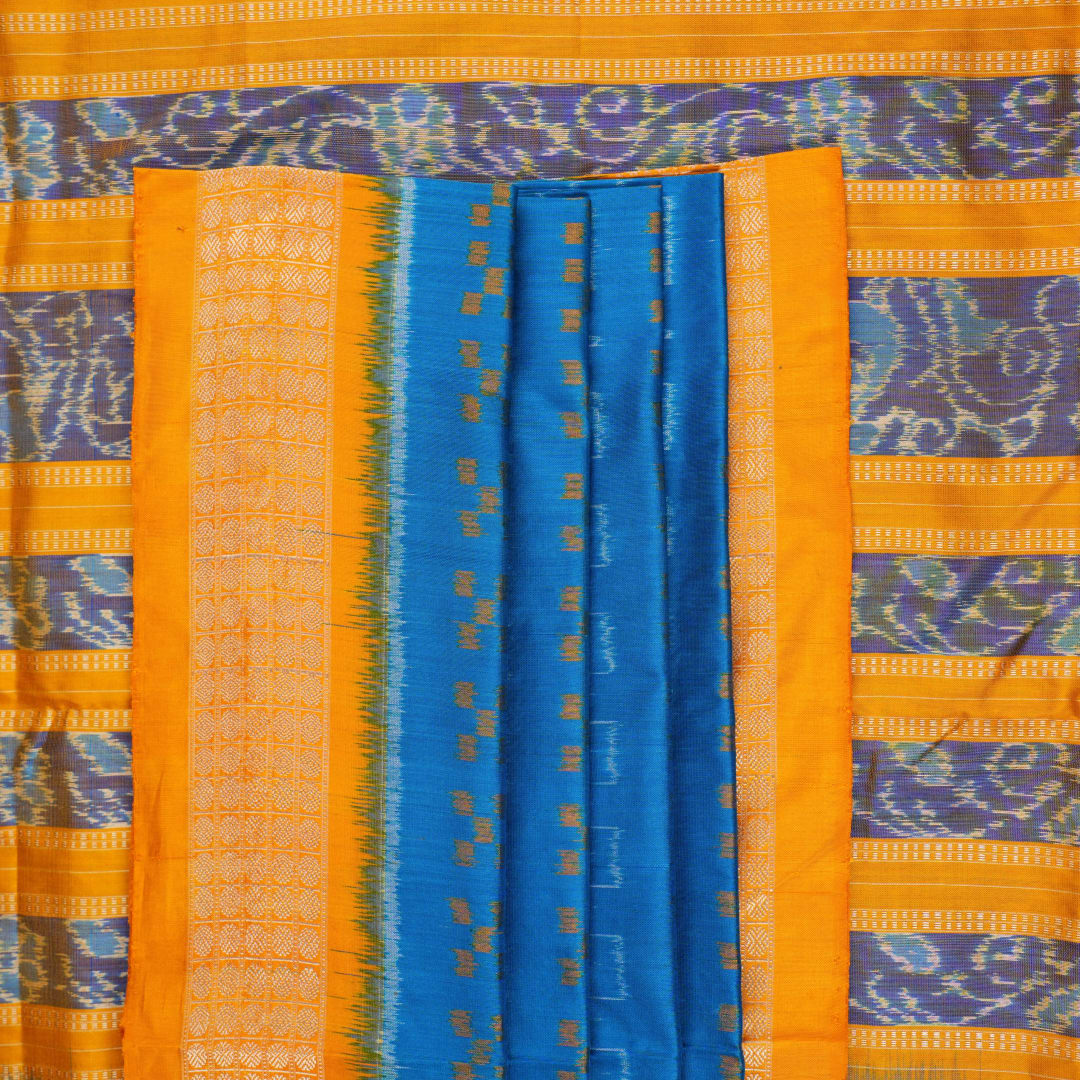 Close-up of the luxurious Sambalpuri silk fabric, highlighting its rich texture and handloom weave in blue and yellow.