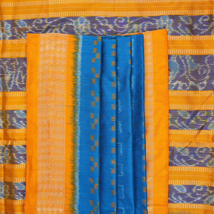 Close-up of the luxurious Sambalpuri silk fabric, highlighting its rich texture and handloom weave in blue and yellow.