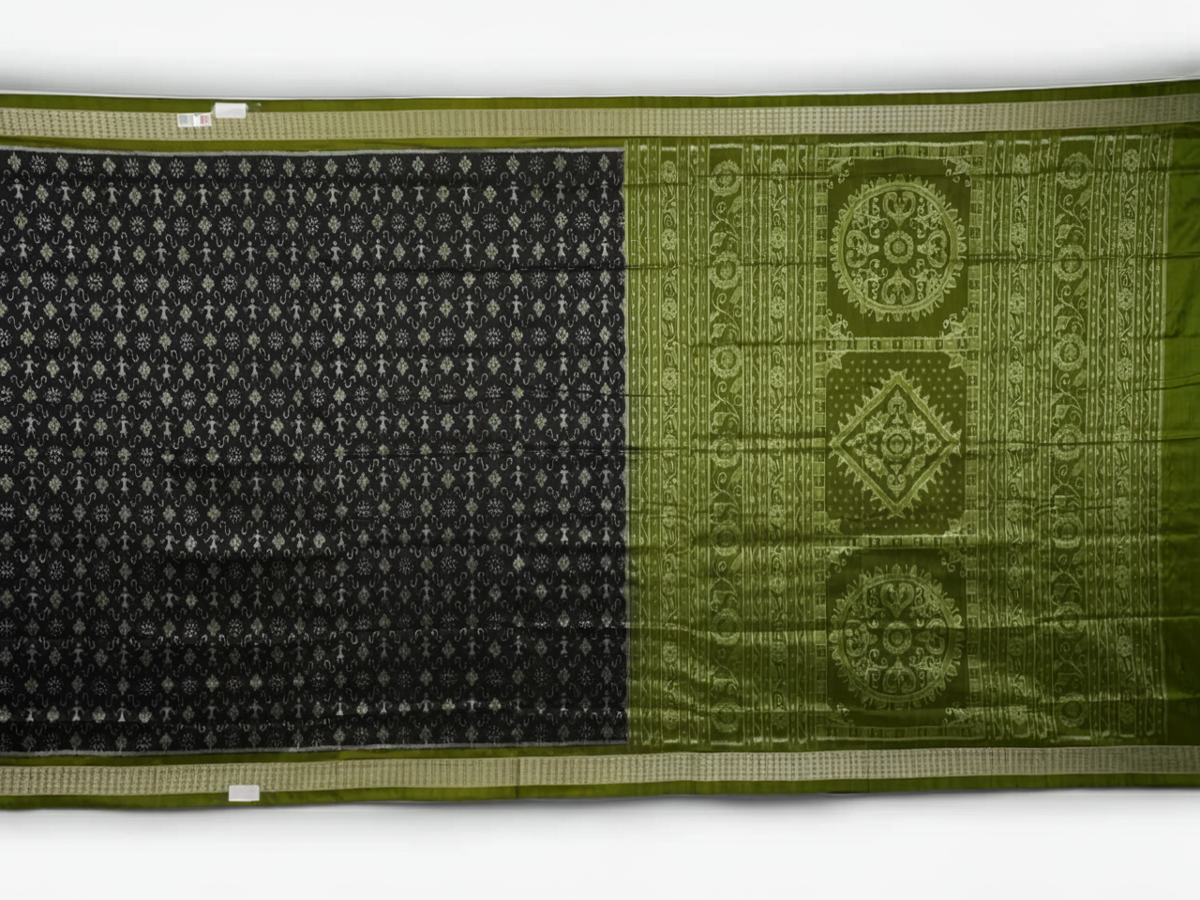 Close-up of the luxurious black and green Sambalpuri silk fabric texture and weave.