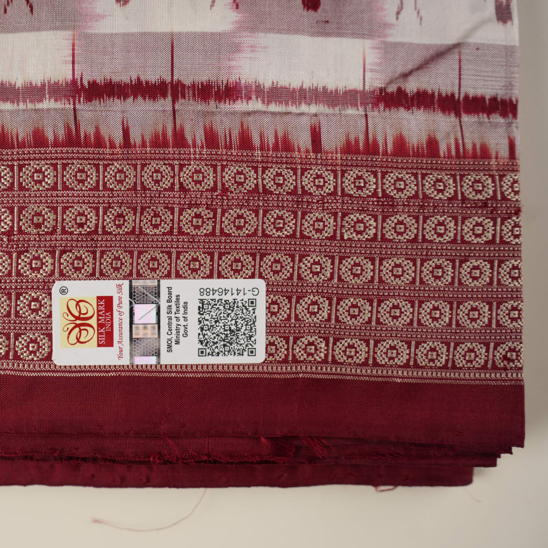 Close-up of the Sambalpuri silk saree fabric, detailing its luxurious texture and fine handloom weave.