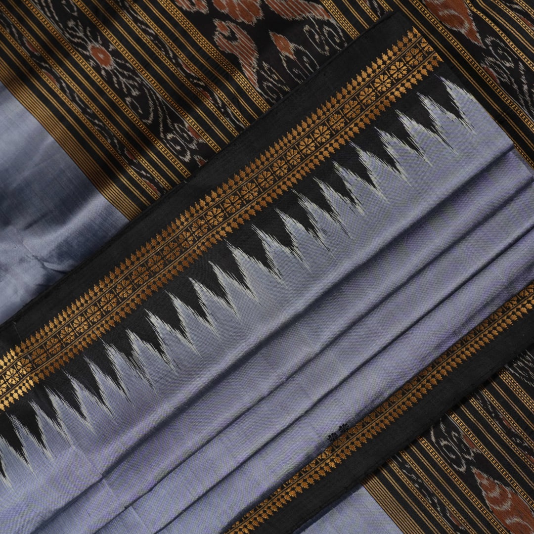 Full styling view of a model wearing a grey and black Khandua silk saree featuring elegant butta motifs.