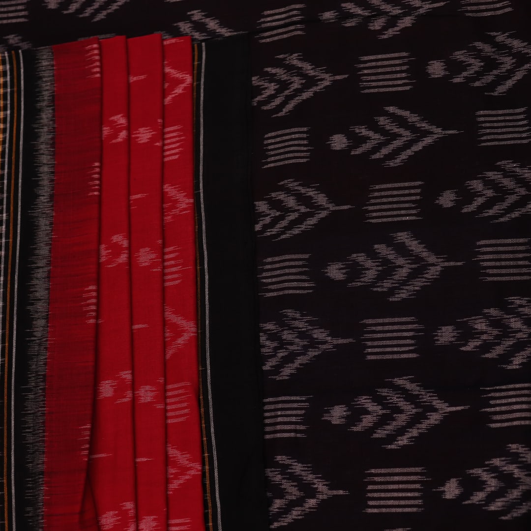 Red and black Sambalpuri cotton saree with motifs, elegantly draped to showcase its style and design.