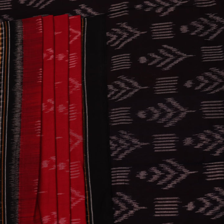 Red and black Sambalpuri cotton saree with motifs, elegantly draped to showcase its style and design.
