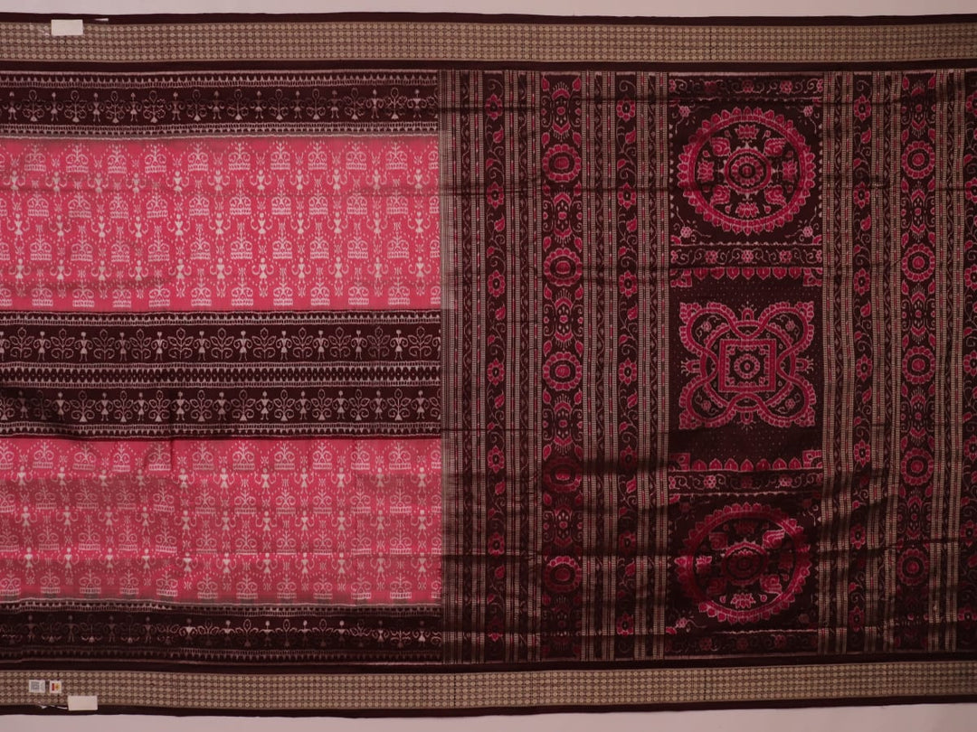 Close-up of peach and maroon Sambalpuri silk saree fabric showing intricate handloom texture and motifs.