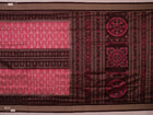 Close-up of peach and maroon Sambalpuri silk saree fabric showing intricate handloom texture and motifs.
