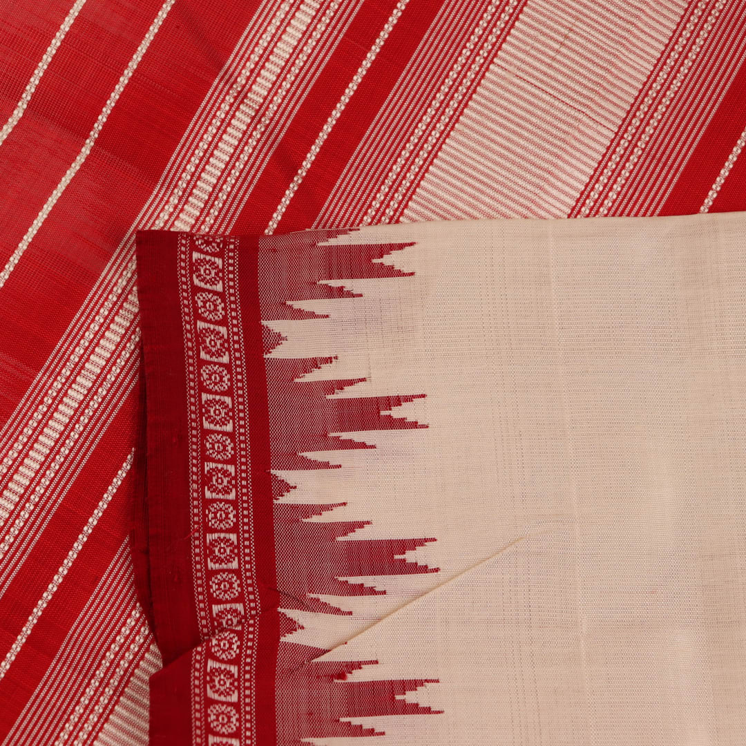 Close-up of plain white silk fabric with intricate Berhampuri weaving in red