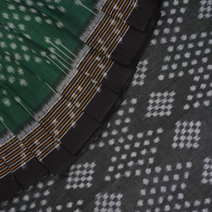 Elegant model draping a green and black Sambalpuri cotton saree with traditional Odisha handloom motifs.