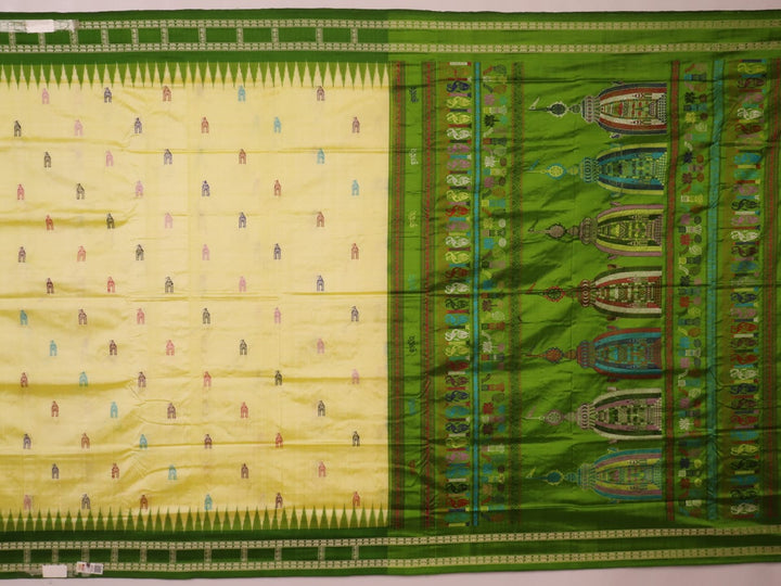 Close-up of cream and green Bomkai Silk Saree fabric texture with butta pattern.