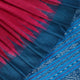 Close-up shot showcasing the textured weave of the tussar silk fabric of a plain pink and blue saree.