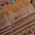 Close-up view of the grey tussar silk fabric texture with subtle butta patterns