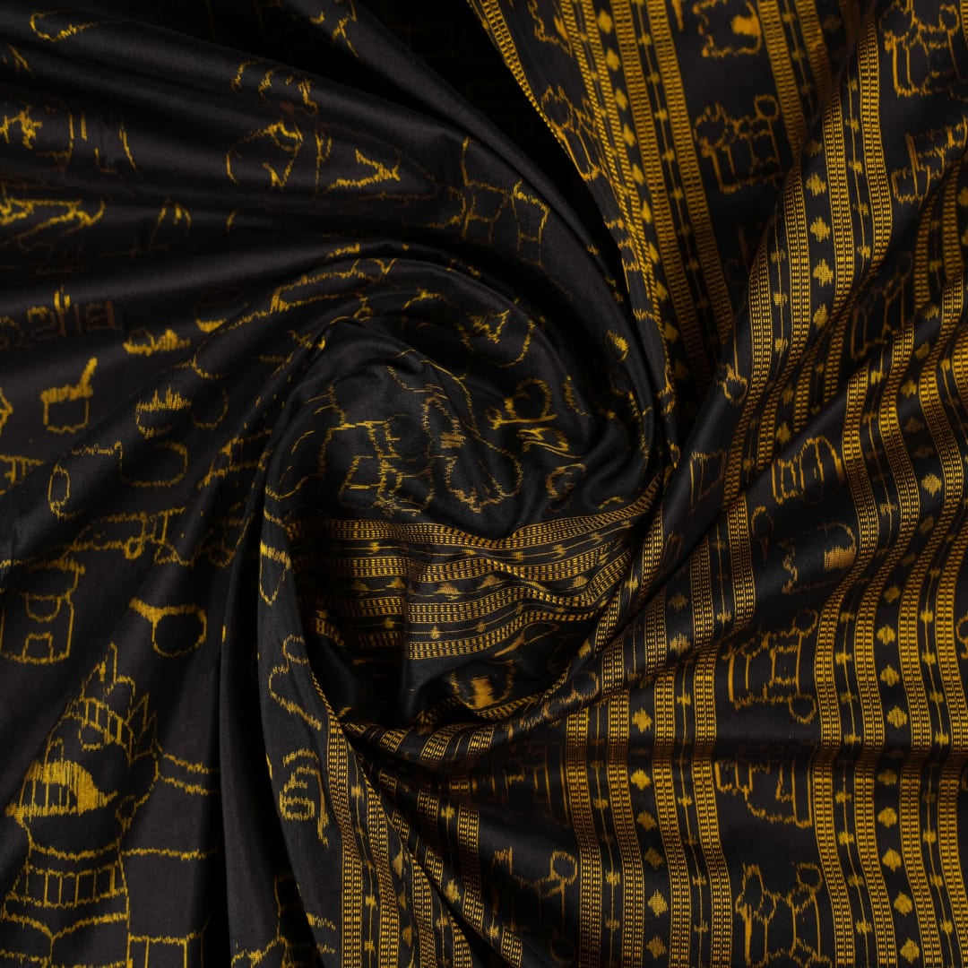 Close-up of the black Sambalpuri silk saree fabric, revealing its rich texture and the intricate weave of the motifs.