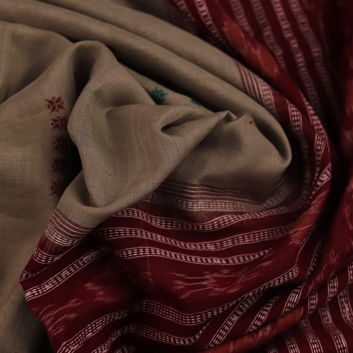 Full view of a traditional green and maroon cotton Bomkai saree featuring a butta pattern.