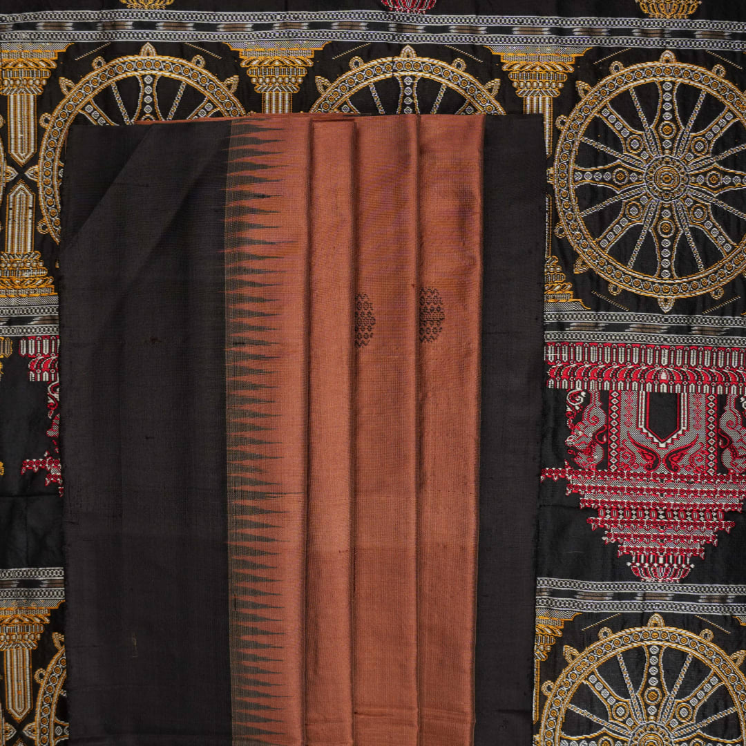 Extreme close-up of brown Bomkai silk saree fabric, revealing rich weave texture and luxurious feel.