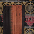 Extreme close-up of brown Bomkai silk saree fabric, revealing rich weave texture and luxurious feel.