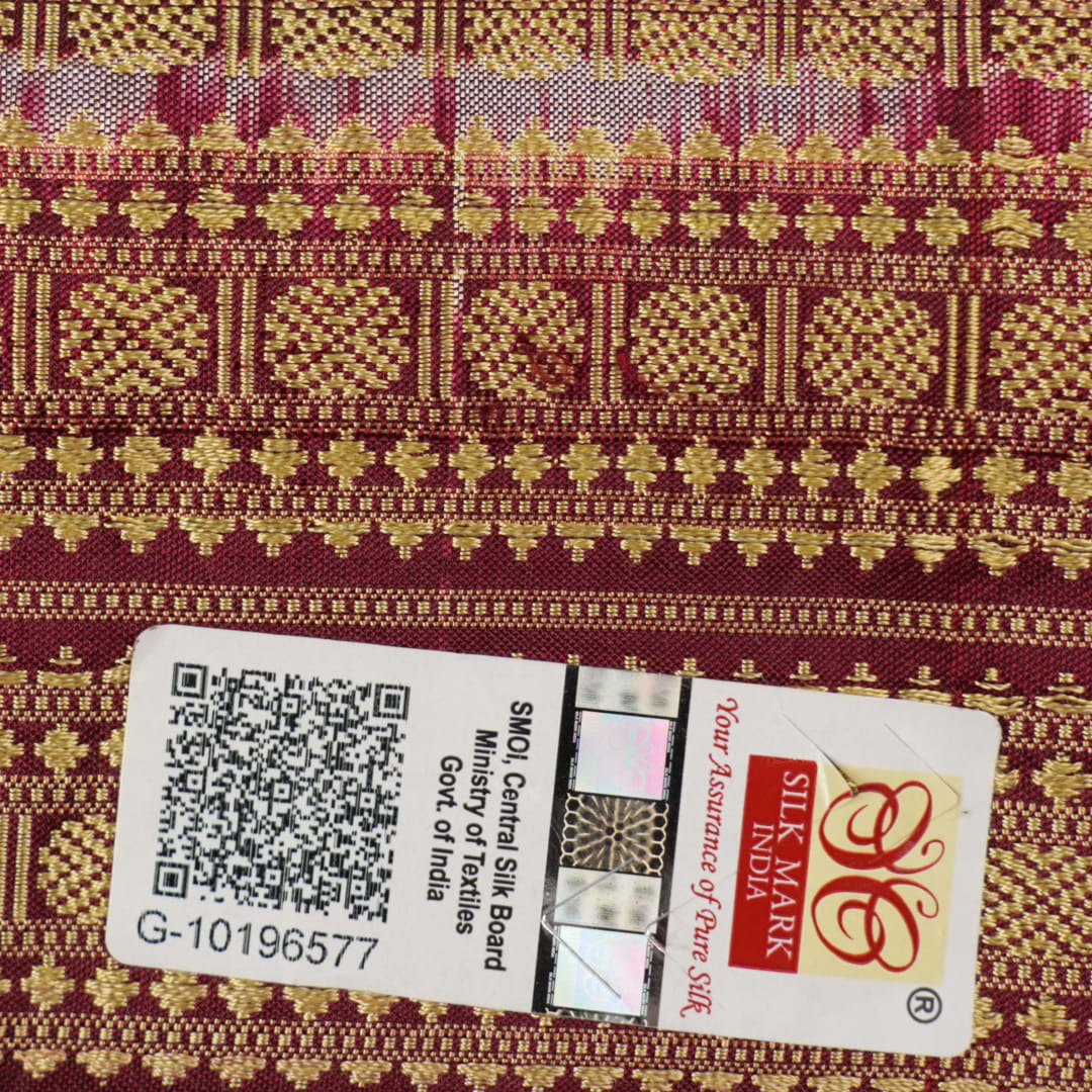 Close-up of the fine silk texture of the white Sambalpuri saree, highlighting its soft sheen and weave.