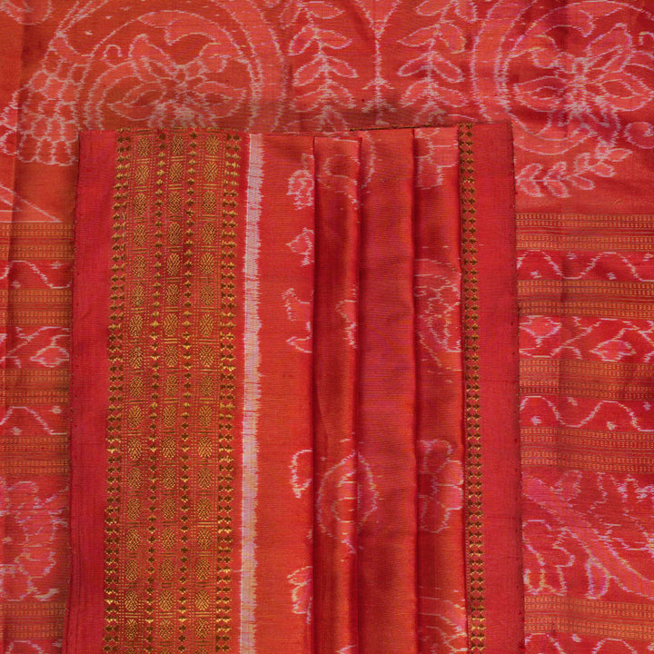 Close-up of rust Sambalpuri silk fabric, revealing its luxurious texture and fine handloom weave.