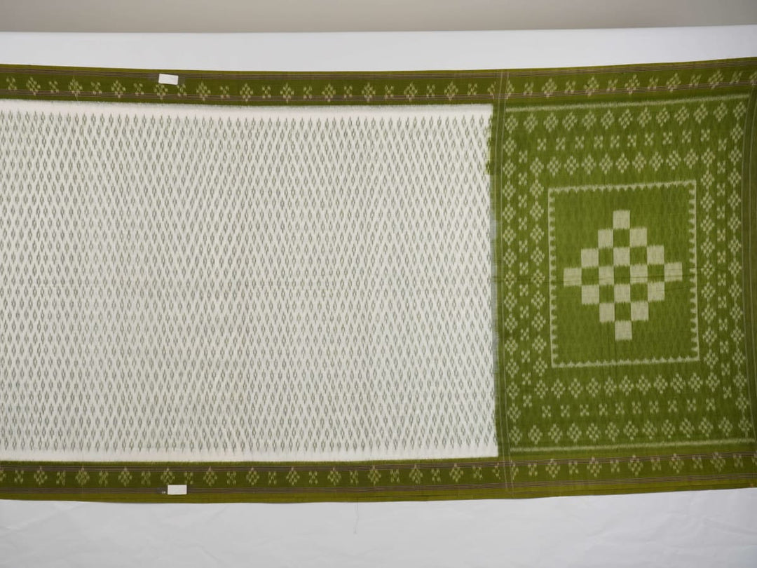 Model wearing a white and green Sambalpuri cotton saree, demonstrating the elegant drape and handloom motifs.